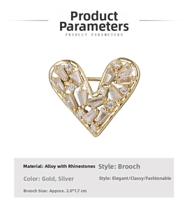 Macro detail of heart-shaped brooch with inlaid crystal rhinestones and golden alloy base