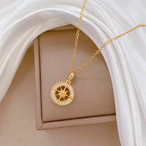 Elegant gold titanium necklace with starburst compass pendant and sparkling crystals