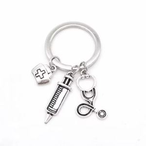Retro silver medical keychain with nurse hat, syringe and stethoscope pendants