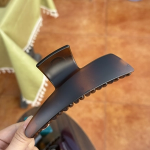 Detailed view of large dark brown butterfly hair claw clip with semi-transparent finish