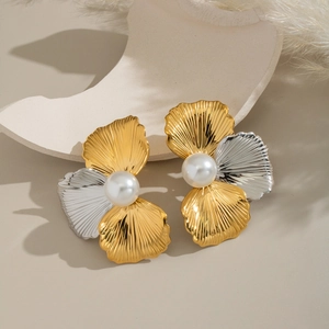 Elegant two-tone stainless steel shell stud earrings with central pearl on beige surface