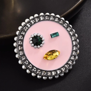 Macro shot of lip-shaped brooch with colorful gems, pearls and sparkling crystals