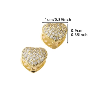 Macro detail of gold heart earrings with zircon inlay showing dimensions of 1cm x 0.9cm