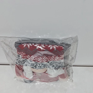 Detail of Christmas gnome chair cover with red knit hat and white snowflake pattern