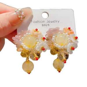 Pink floral S925 silver earrings with crystal drop and pearls shown in a hand-held view