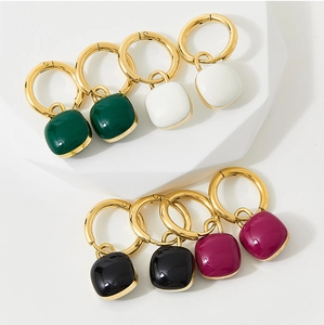 Detail of square candy-colored enamel drop earrings in four colors on stone props