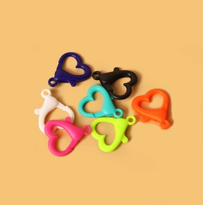Close-up of colorful acrylic heart-shaped lobster clasps for DIY jewelry making crafts