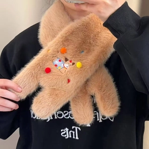 Detail of plush brown scarf featuring cartoon dachshund embroidery and colorful pompoms