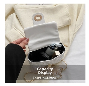 Detail of white quilted crossbody bag showing internal capacity for lipstick and makeup