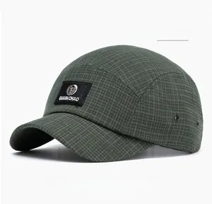 Detail of military green check pattern camp cap with brand patch and metal eyelets