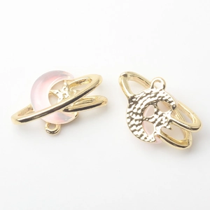 Macro shot of pink resin moon pendant with golden alloy frame for DIY jewelry making