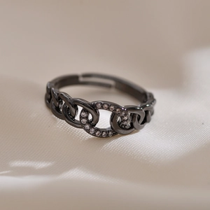 Macro view of black chain ring with inlaid sparkling rhinestones and open adjustable design