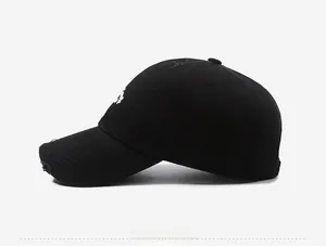 Close-up of distressed brim and white embroidery on a black cotton vintage baseball cap