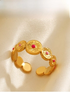 Detail of 18K gold plated ring with pink enamel circles on silk fabric backdrop