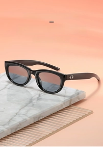 Detail of vintage cat-eye sunglasses with black frame and silver temple metal accents