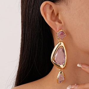 Exaggerated geometric acrylic triangle drop earrings with gold trim on model