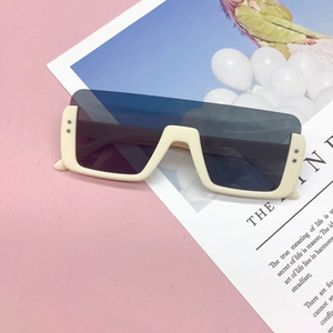 Detail shot of ivory thick-framed oversized children's sunglasses with gradient shield lenses