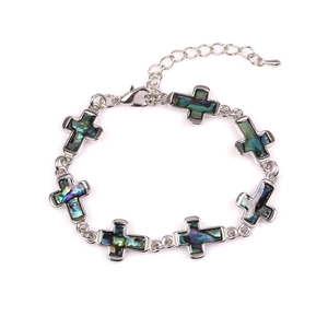 Silver cross bracelet with natural abalone shell inlays and adjustable chain on white