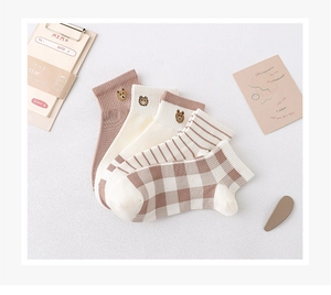 Detail showing five pairs of cute bear embroidery cotton socks in brown and beige tones