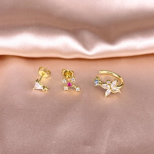 Detail of S925 silver gold-plated set with butterfly cuff and zircon cross stud