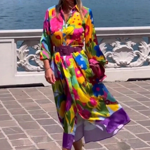 Floral long sleeve shirt dress with purple belt shown in a scenic outdoor setting