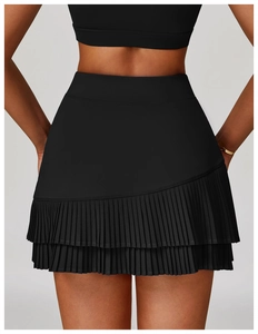 Detail view of the asymmetric pleated hem on high-waist black athletic sports skirt