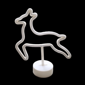 Detailed view of LED neon deer lamp on a white base against a solid black background