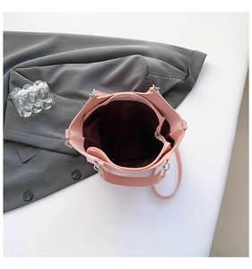 Top view of pink bucket bag showing large interior capacity and dark lining detail