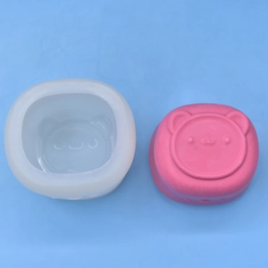 Cartoon bear and animal shaped silicone mold for DIY candles and soap making on blue surface