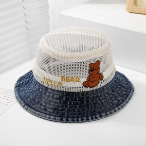 Detail of breathable white mesh top and blue denim brim with cute bear embroidery