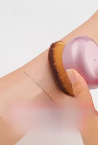 Detail showing high-density fiber bristles and curved head design for smooth makeup application