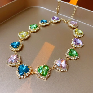 Close-up of colorful heart-shaped crystal necklace with gold plated chain links