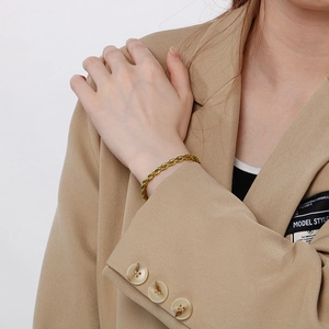 Classic 18K gold plated stainless steel rope chain bracelet worn on a female wrist