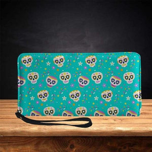 Minimalist long skull wallet with colorful floral pattern and wristlet strap on wood
