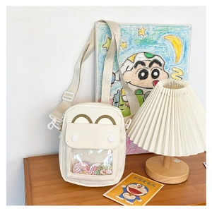 Close-up of white Japanese ita bag with transparent PVC window for anime badge display
