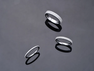Macro shot of three stacked 925 silver eternity rings with double-row crystals