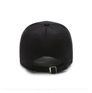 Detail view of adjustable metal buckle on a classic black cotton baseball cap