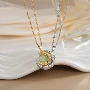 Macro view of gold and silver moon necklaces with cat eye stones and cubic zirconia