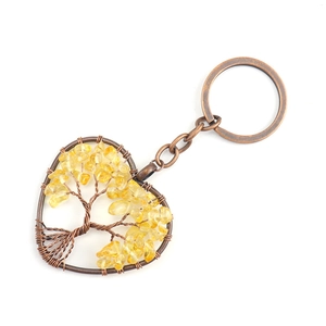 Detail of tree of life heart keychain with yellow crystal stones and copper wire wrapping