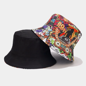 Detail view of 80s party graffiti print and plain black reversible bucket hat