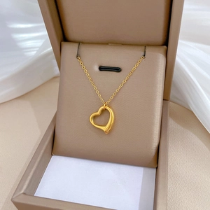 Gold plated titanium steel necklace with open heart pendant inside a jewelry box