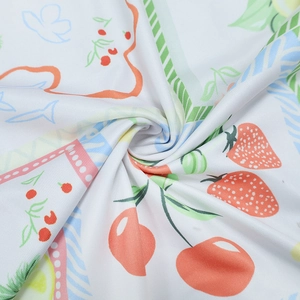 Macro shot of breathable summer fabric with cute strawberry and cherry fruit print