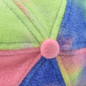 Macro view of colorful plush fleece segments and center button on the baseball cap top