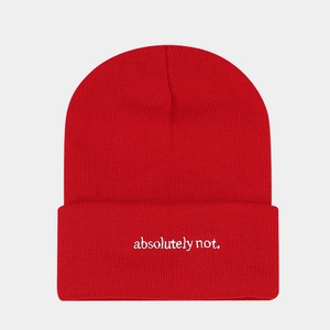 Close-up of red ribbed knit beanie featuring white 'absolutely not.' slogan embroidery