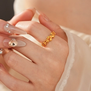 Detail shot of vintage gold bow ring showing the hollow design and textured matte finish