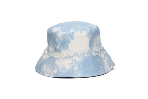 Close-up of tie-dye bucket hat showing light blue and white cotton canvas fabric texture