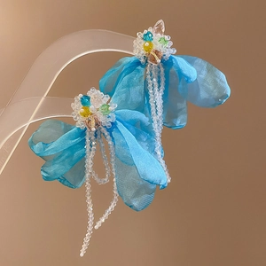 Detailed view of elegant blue fabric petal earrings featuring sparkling crystal clusters
