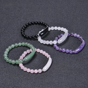 Detailed top view of colorful beaded stone bracelets with curved metal tube accents