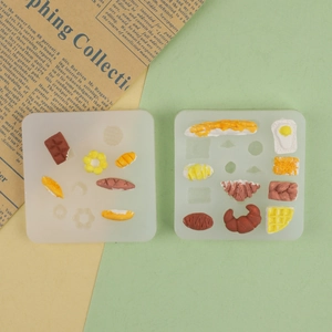 Mini silicone molds for donuts, croissants, and waffles in a set of two square trays