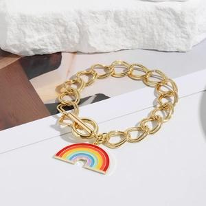 Detail of gold chain necklace featuring a rainbow enamel charm and OT toggle clasp